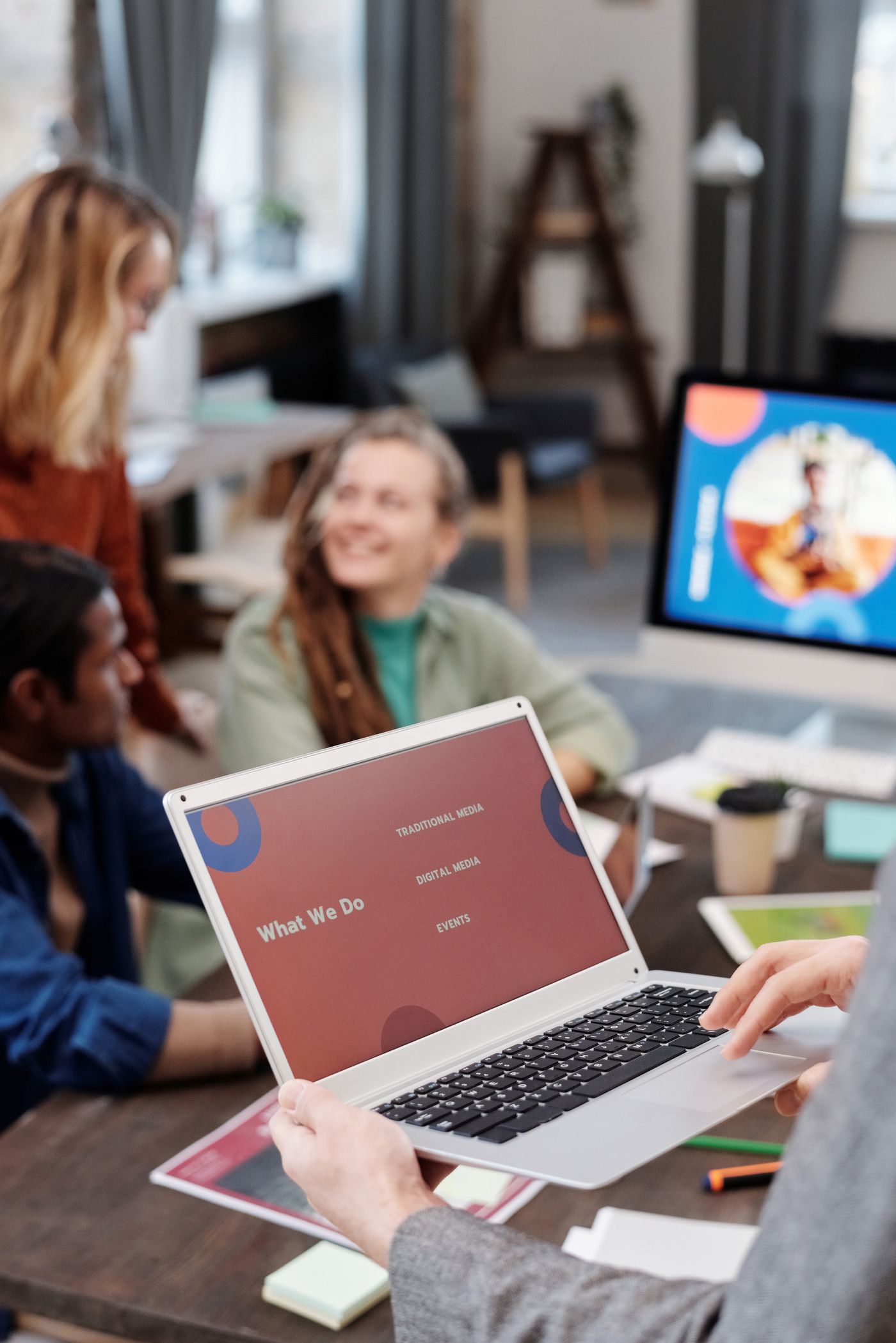 A team discussing marketing plans with a laptop presentation